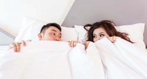 man and woman in bed