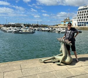 hilary topper on a dock in Faro, Portugal