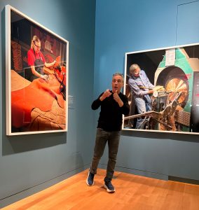 artist standing next to his work